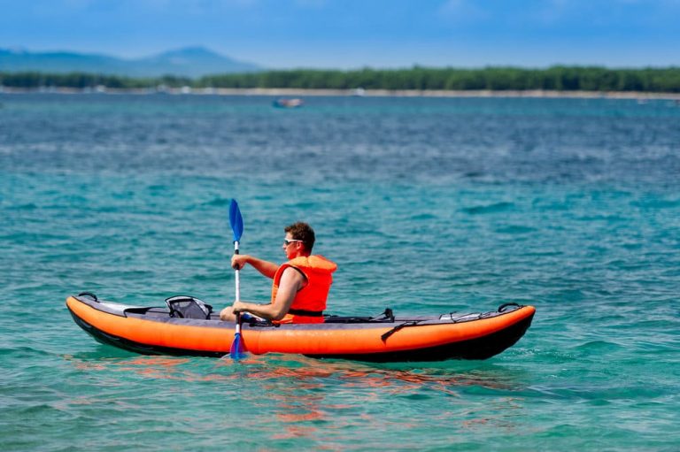 a man using inflatable kayak on the sea