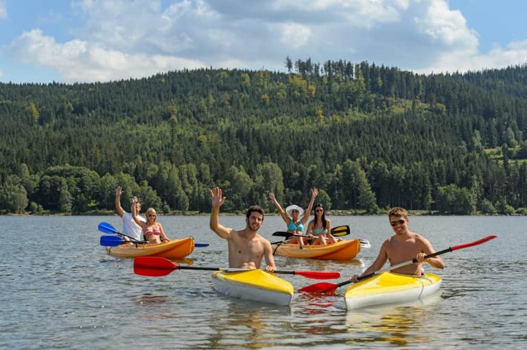 friends enjoy kayaking on inflatable and hard shell kayaks