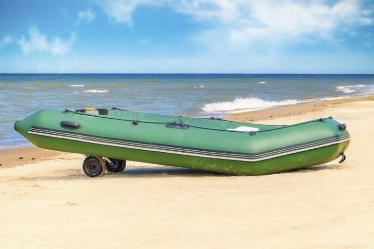 an inflatable boat with transom wheels on the shore