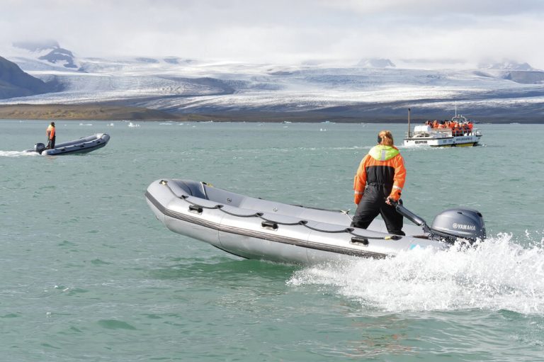 a woman standing on Solstice inflatable boat