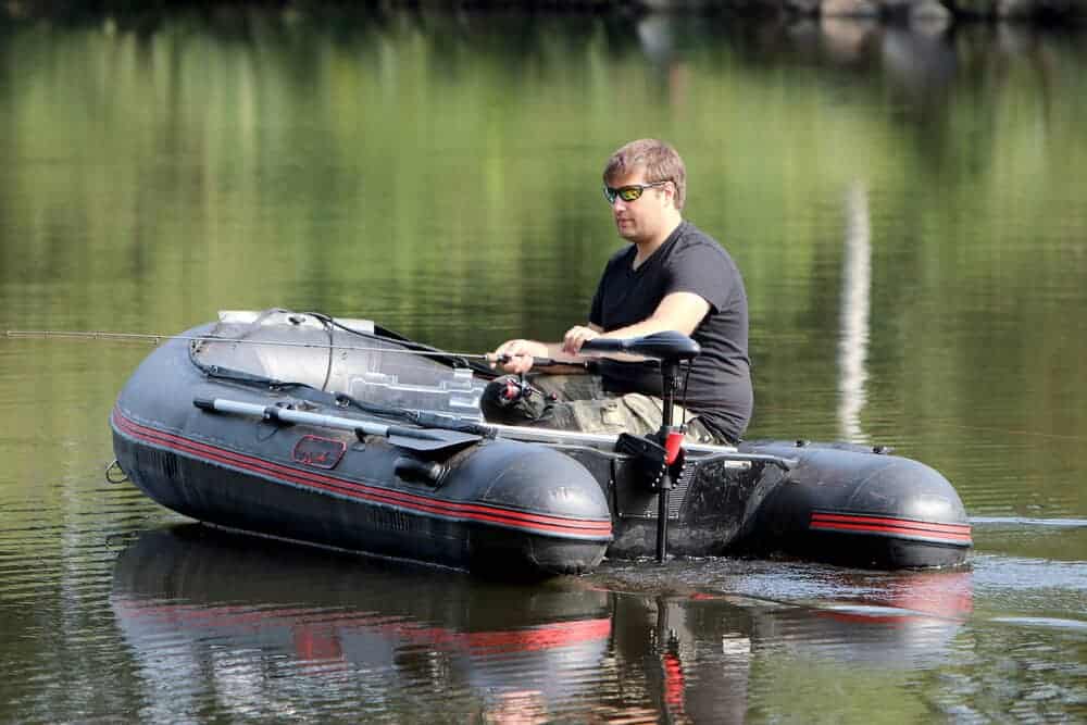man on inflatable boat with Minn Kota Endura C2 trolling motor fishing on a river
