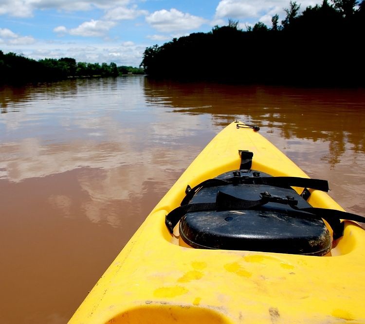 a yellow kayak going upstream