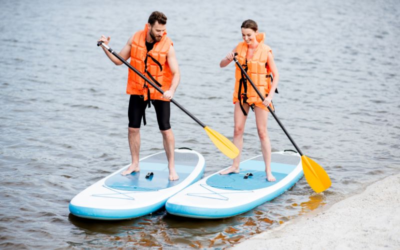 a couple on stand-up paddleboards