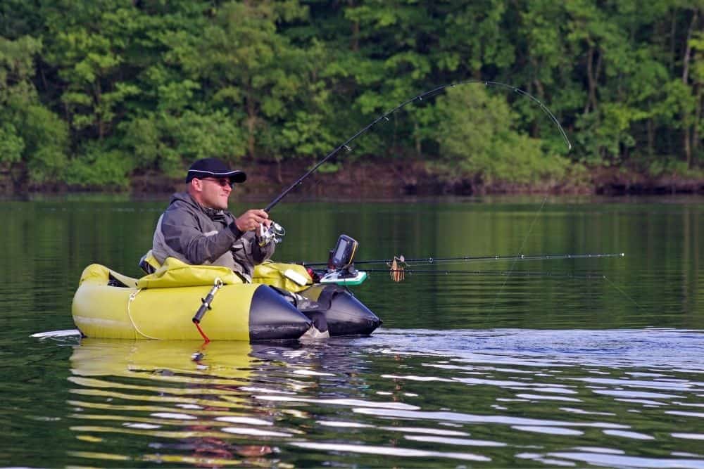 a man in float tube fishing on a river