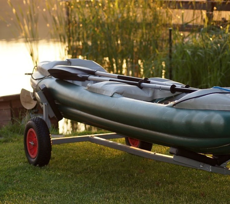 an inflatable canoe with its trailer