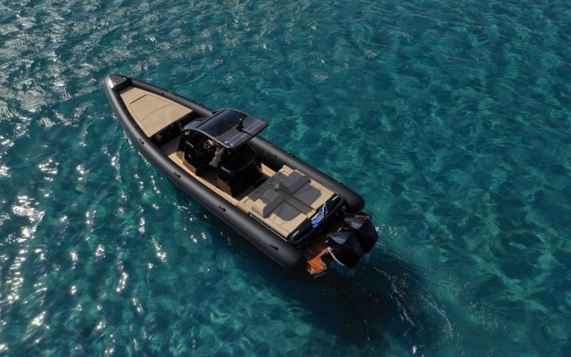 black high speed rigid inflatable boat in the clear water sea