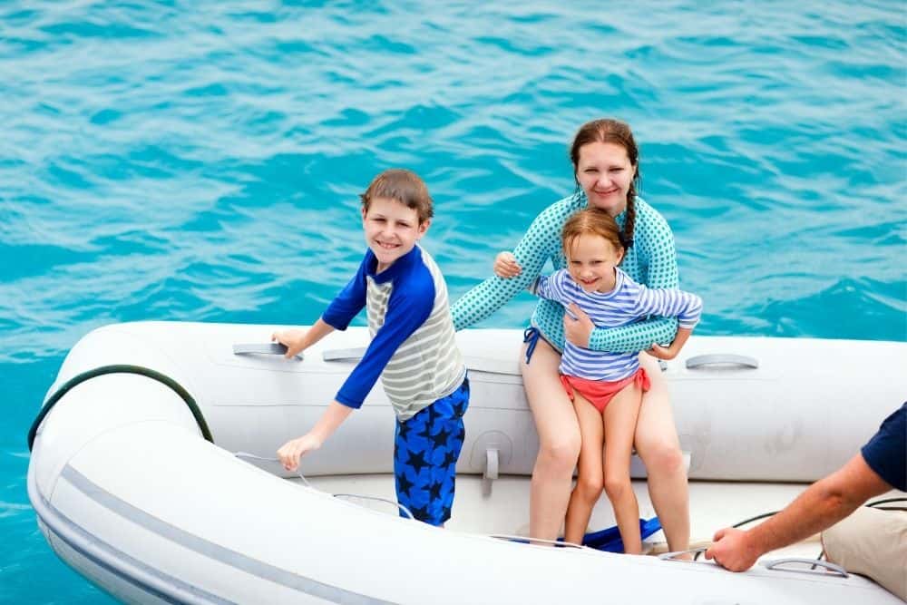 family in a dinghy inflatable boat