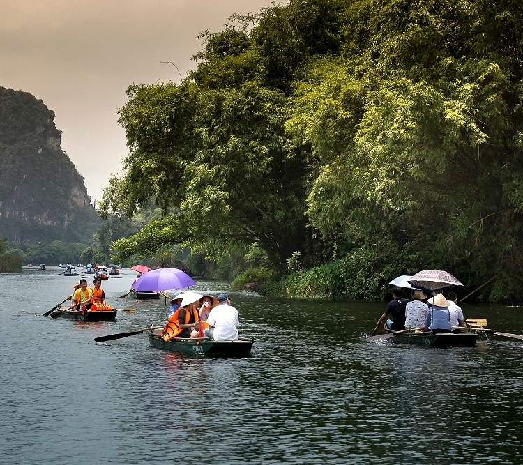 people using jon boats to travel on a river
