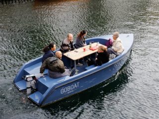 a group of friends on a boat running by a torqeedo motor