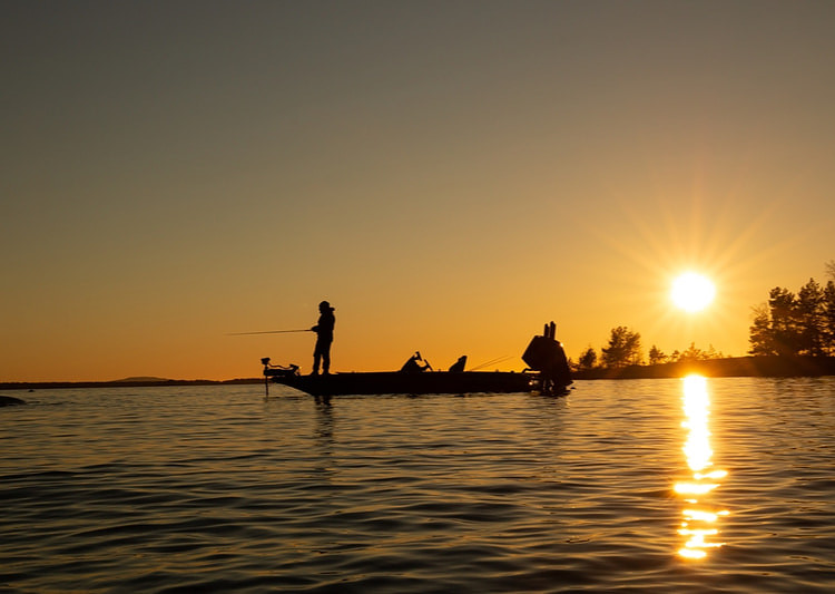 a person goes fishing at noon on a big river