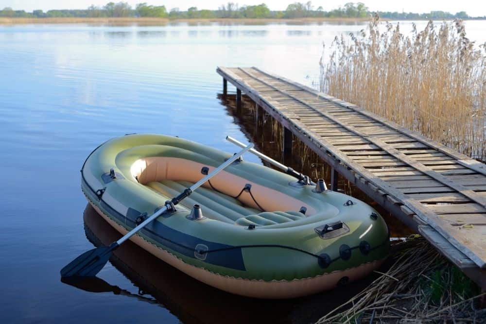 a soft green inflatable boat at the boat ramp