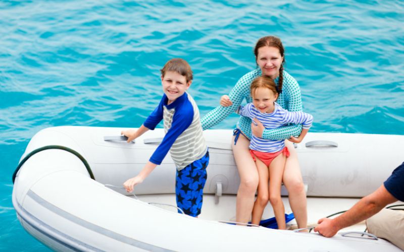 family on a white inflatable boat with large tubes