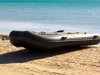 inflatable boat is placed on a seashore