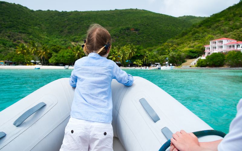 little girl standing on an inflatable boat