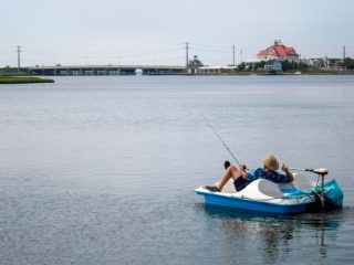 man enjoying fishing on a paddle boat with a trolling motor