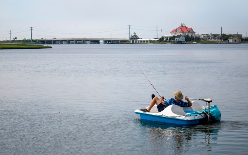 man enjoying fishing on a paddle boat with a trolling motor