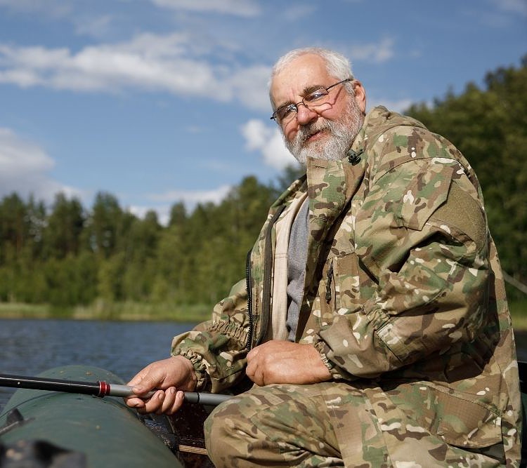 old man fishing on an inflatable boat