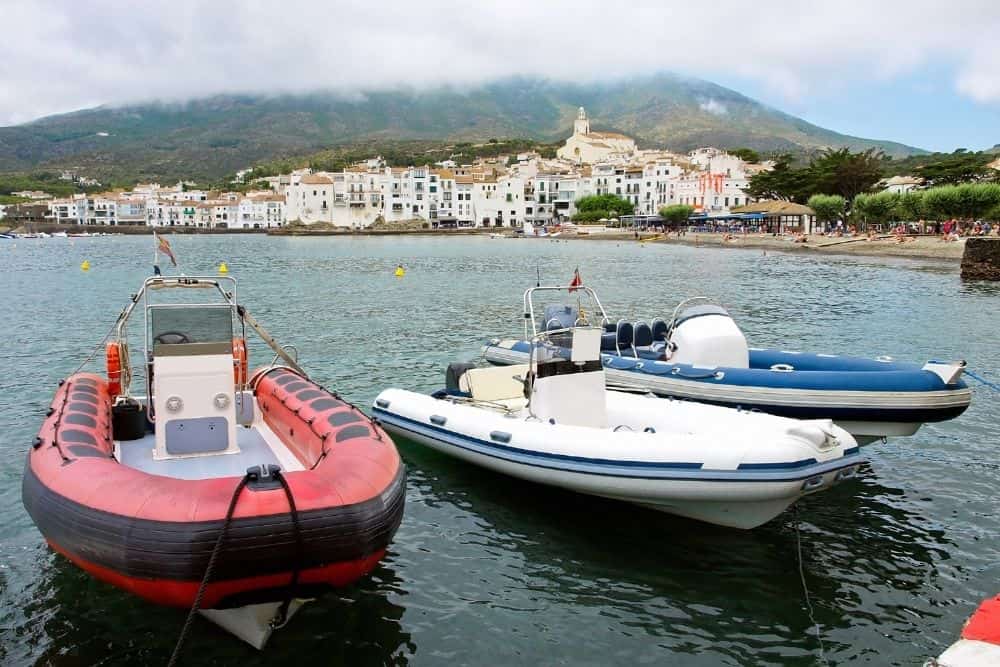 red, white, blue rigid inflatable boats at the dock