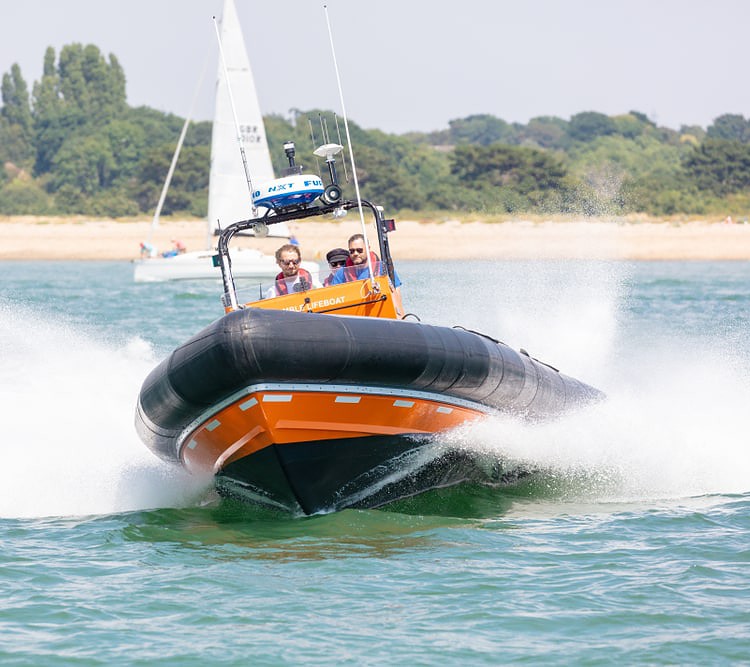 a high speed RIB With Three Men on board