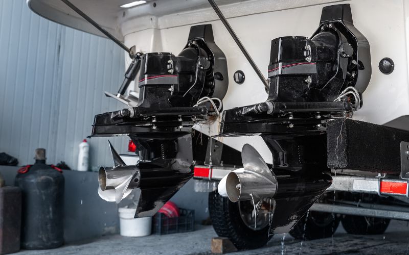 two boat outboard motors in a maintenance garage