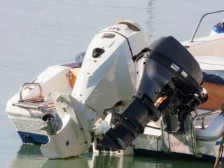 two outboard motors attached to boats