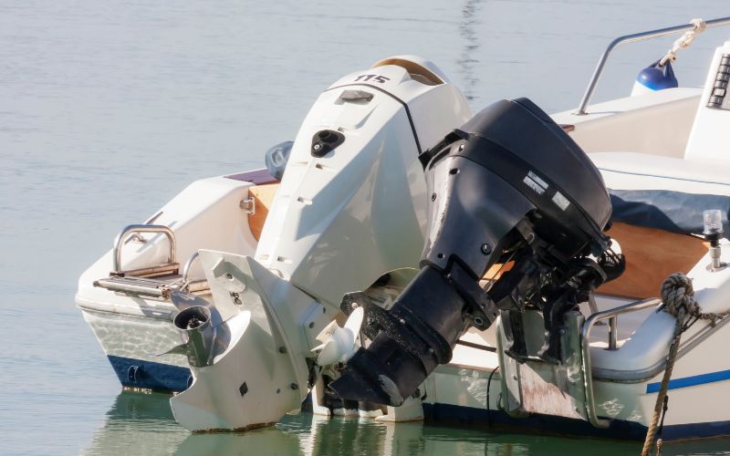two outboard motors attached to boats