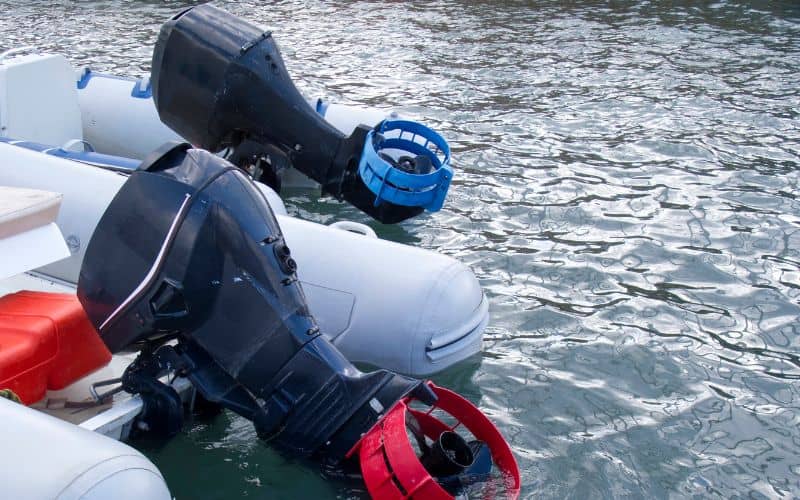 two outboard motors are attached to white inflatable boats
