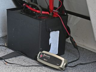 marine battery is charged with a trickle charger on a boat