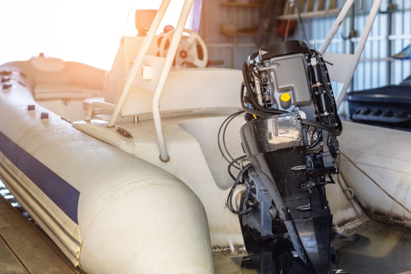 repairing an inflatable motorboat engine at boat garage