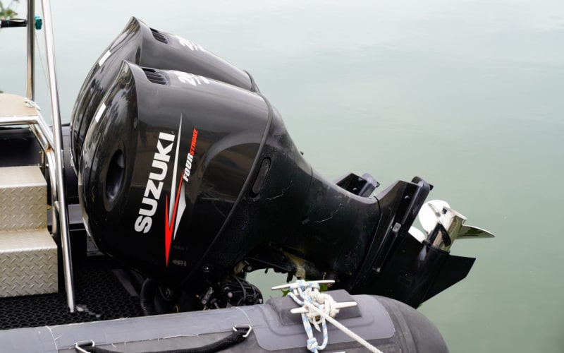 Suzuki four-stroke outboard motors attached on a boat