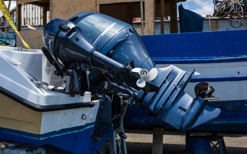 a big outboard motor is mounted on the boat