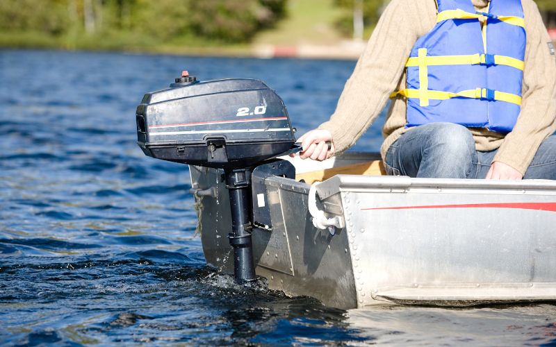 a man using outboard motor on a boat to go to the sea