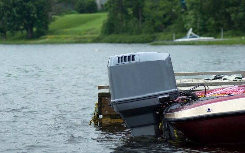 an outboard motor is stowed down with the motor head submerged underwater