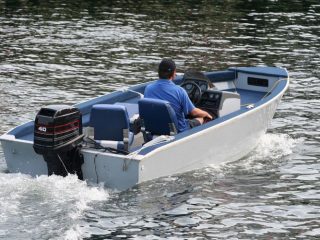 man running boat with an outboard motor