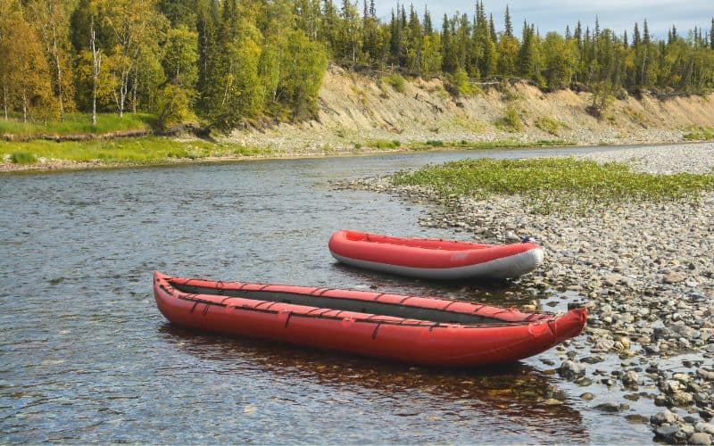 two red inflatable kayaks on the water