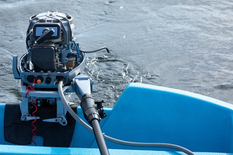 uncovered 2-stroke outboard motor on boat stern