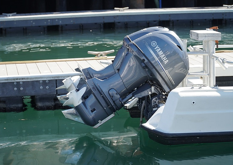 2 outboard motors mounted to the stern of boat