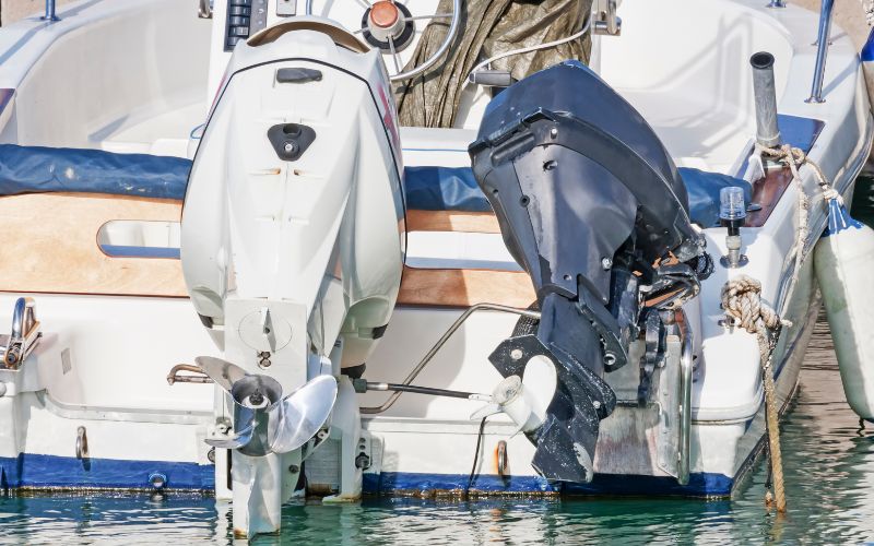 two outboard motors are mounted on the same boat in different ways