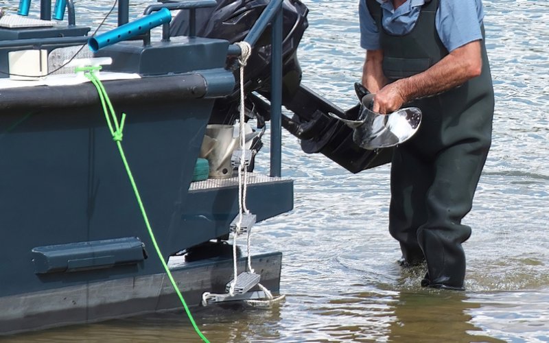 a man is checking the damage on a motor propeller