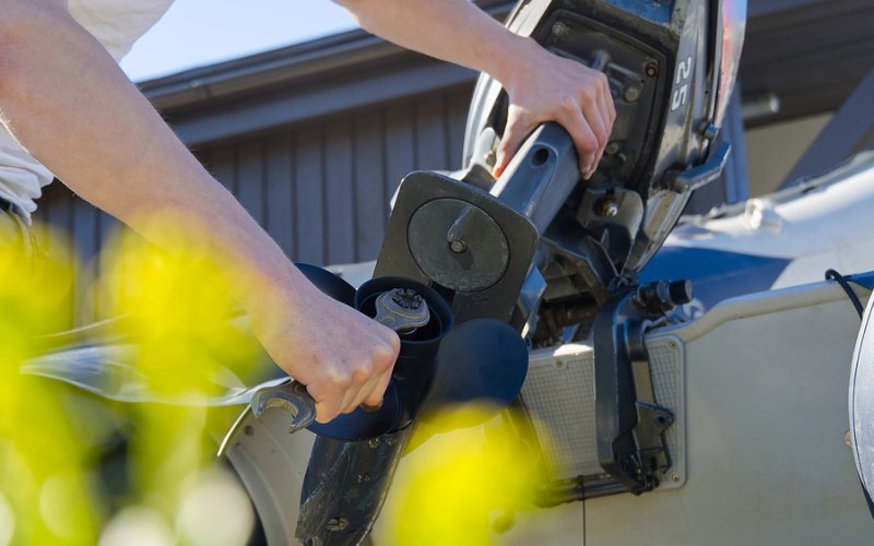 a man is checking the prop shaft of a motor