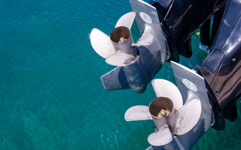 two propellers of outboard motors on the water