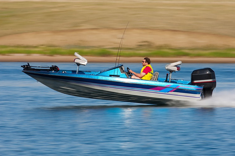 man driving fast boat panned motion