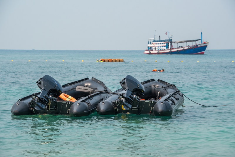 two black rigid inflatable boat on water